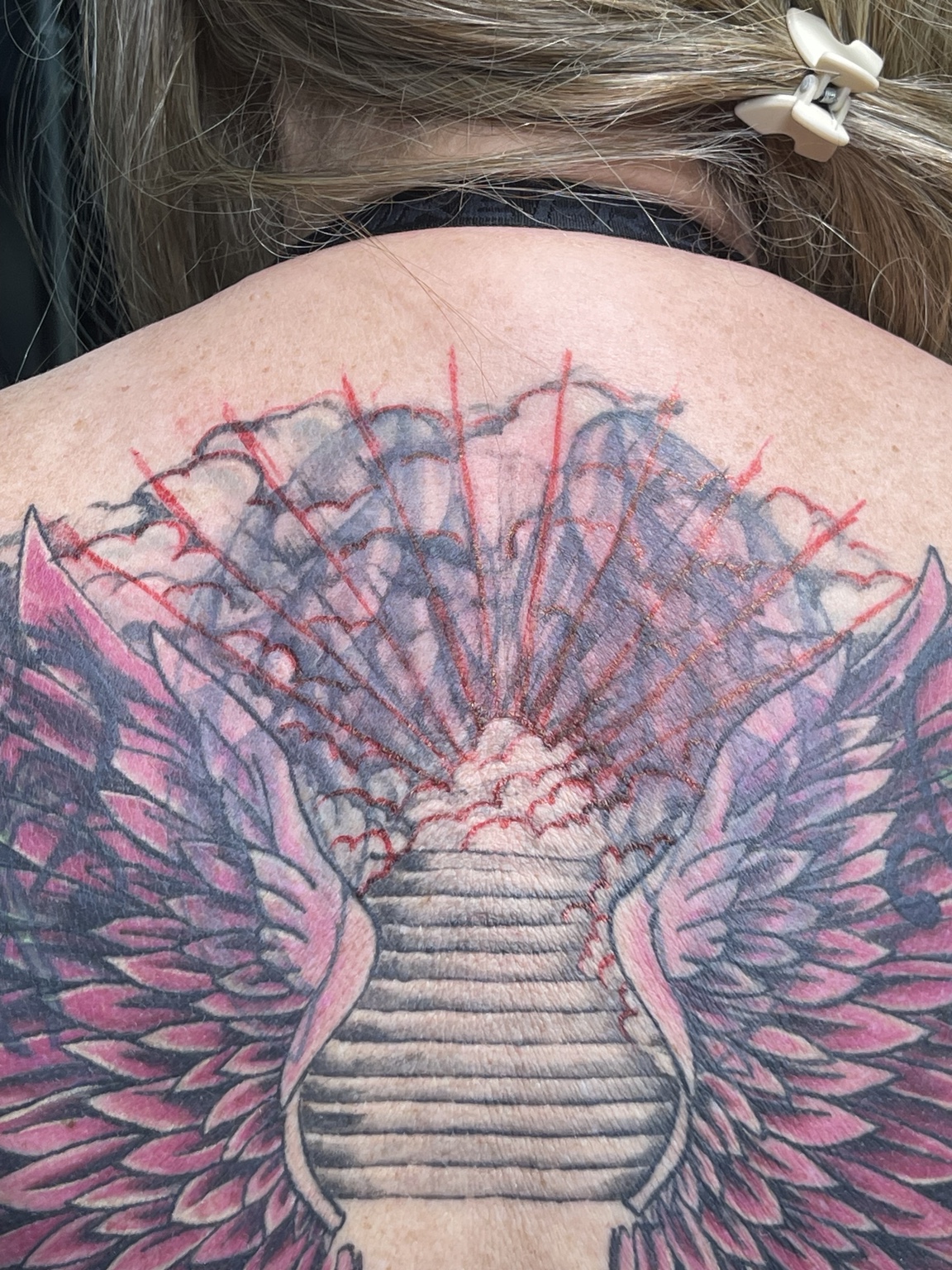 Detail view of large winged back tattoo