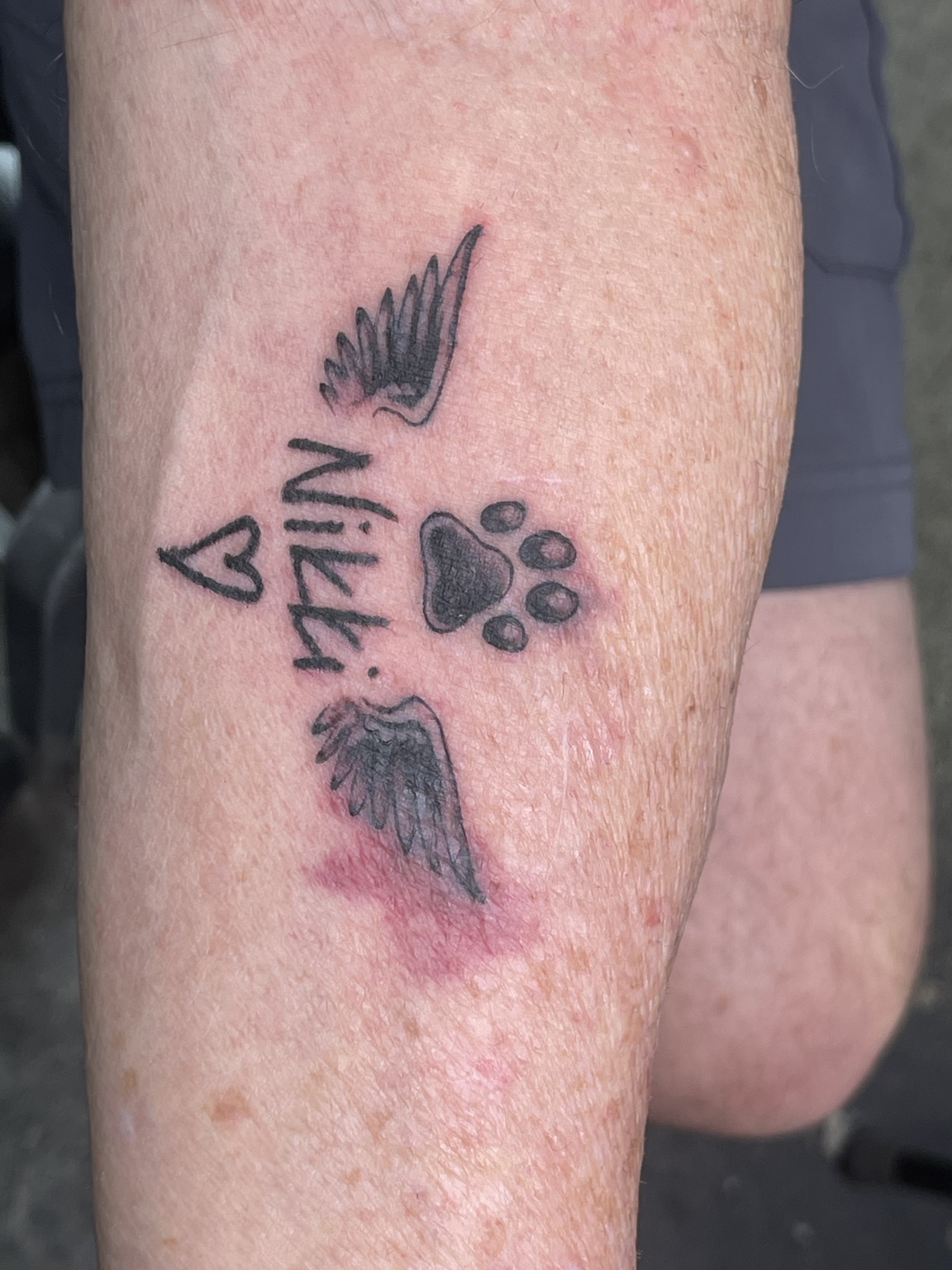 Memorial paw print tattoo