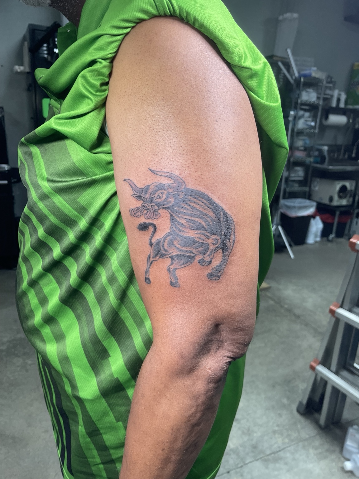 Small eagle upper arm tattoo