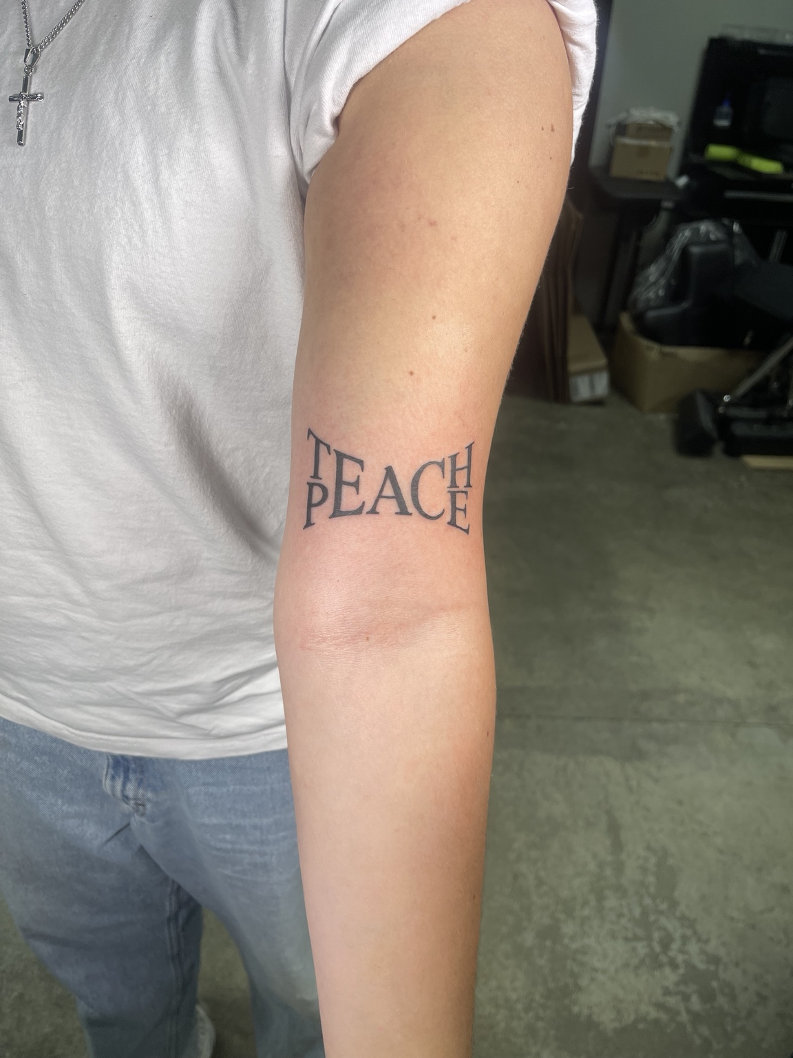 PEACE lettering tattoo