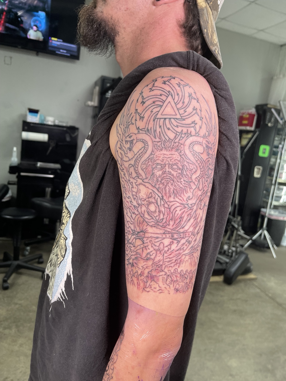 Dense ornamental upper arm tattoo