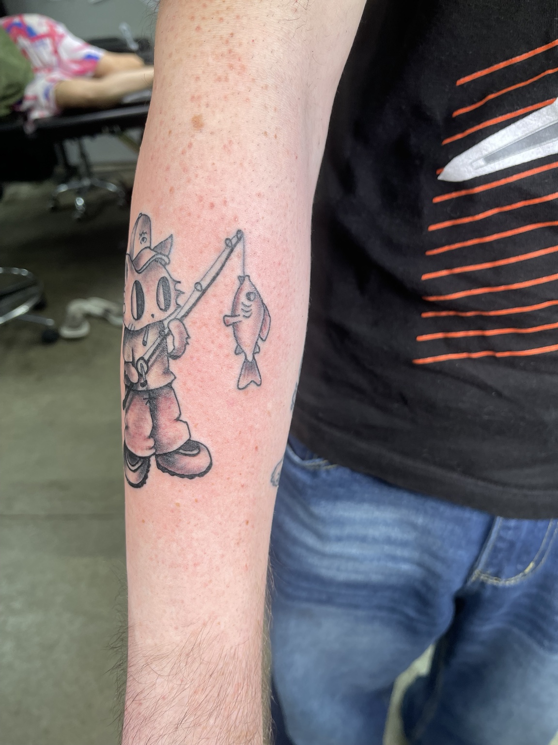 Cartoon forearm tattoo second view
