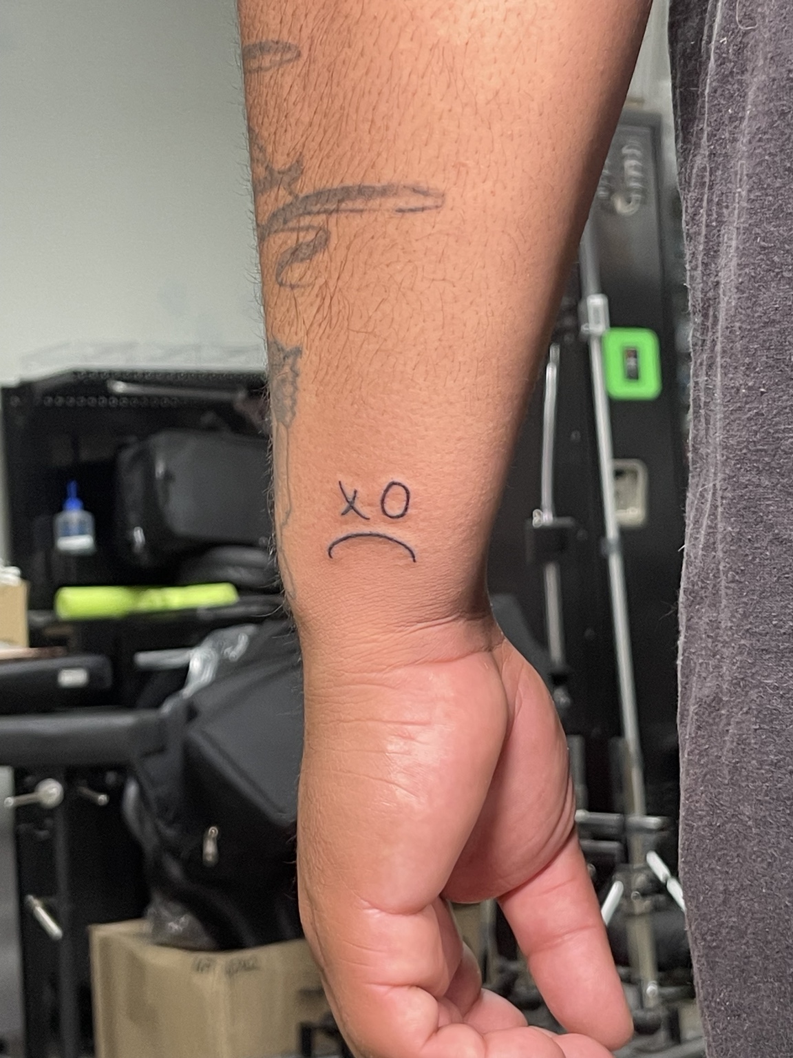 Small wrist symbol tattoo first view