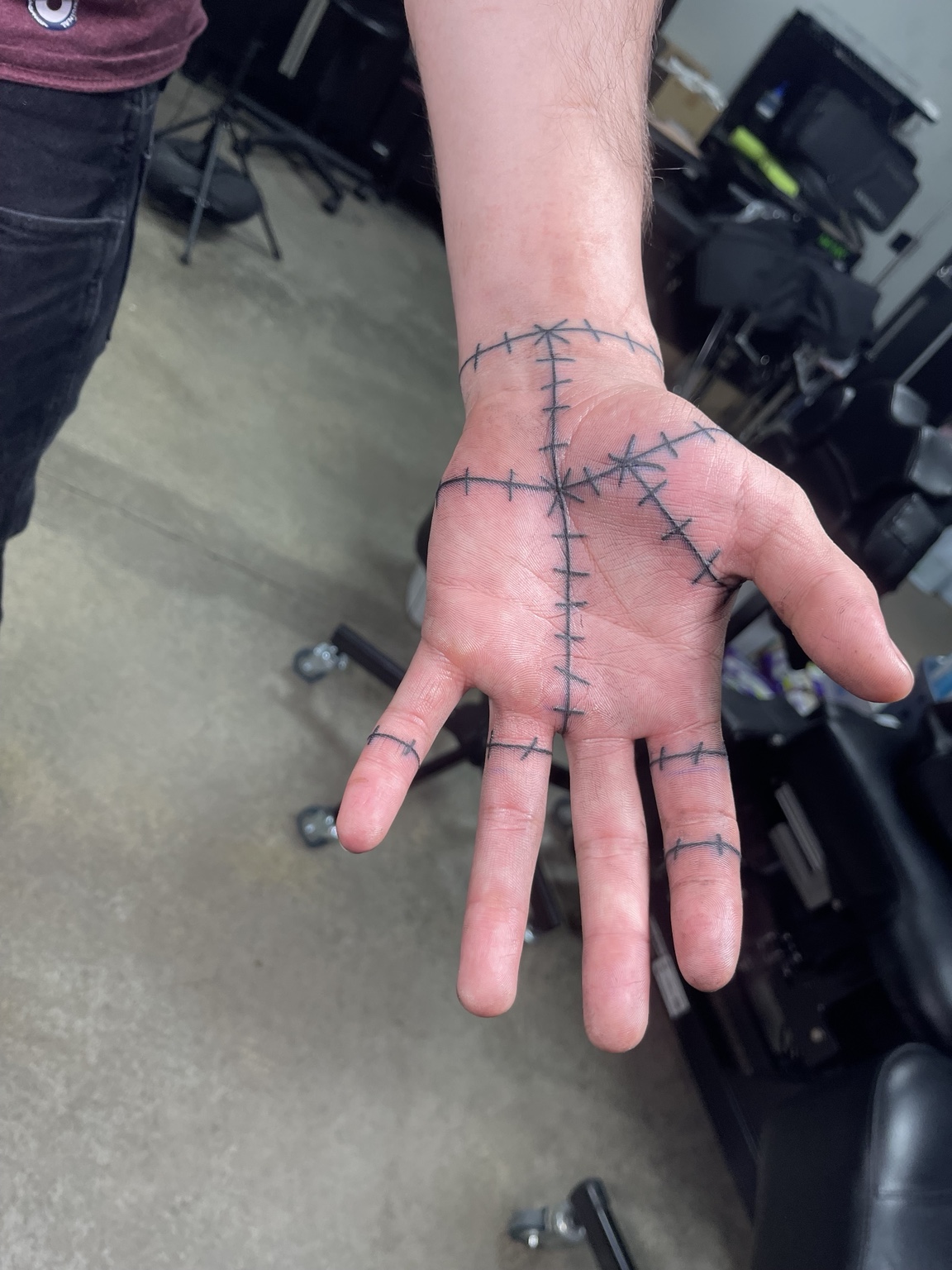 Stitched line hand tattoo view three