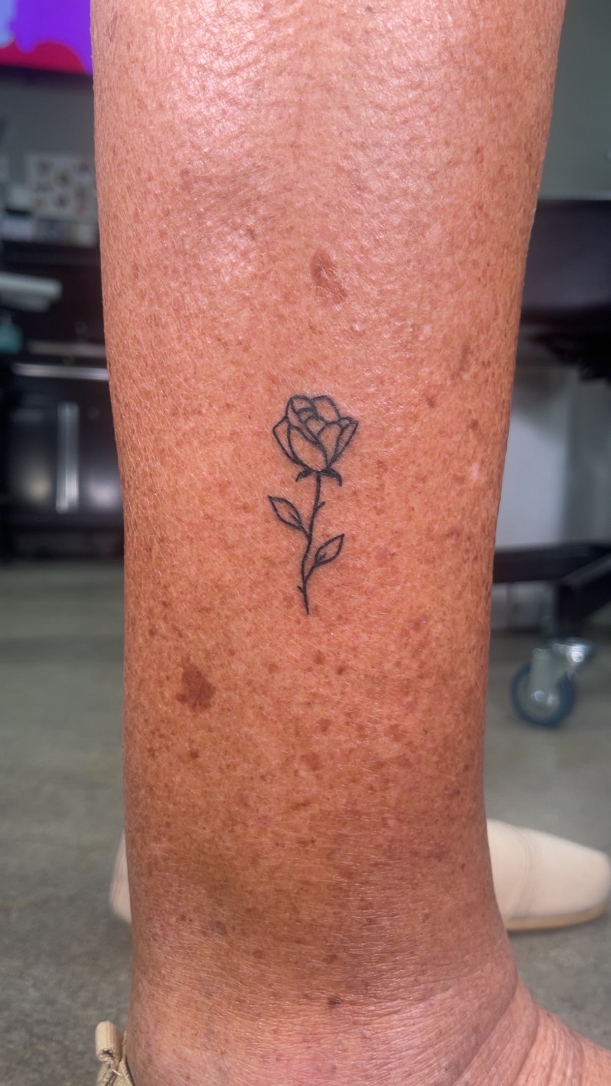 Small rose line tattoo