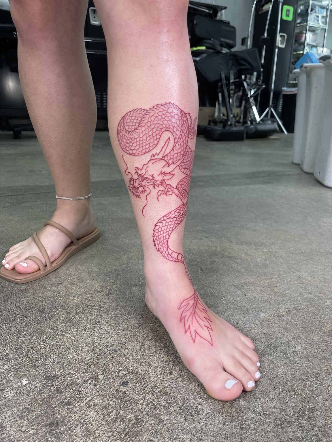 Red outline leg tattoo process view three