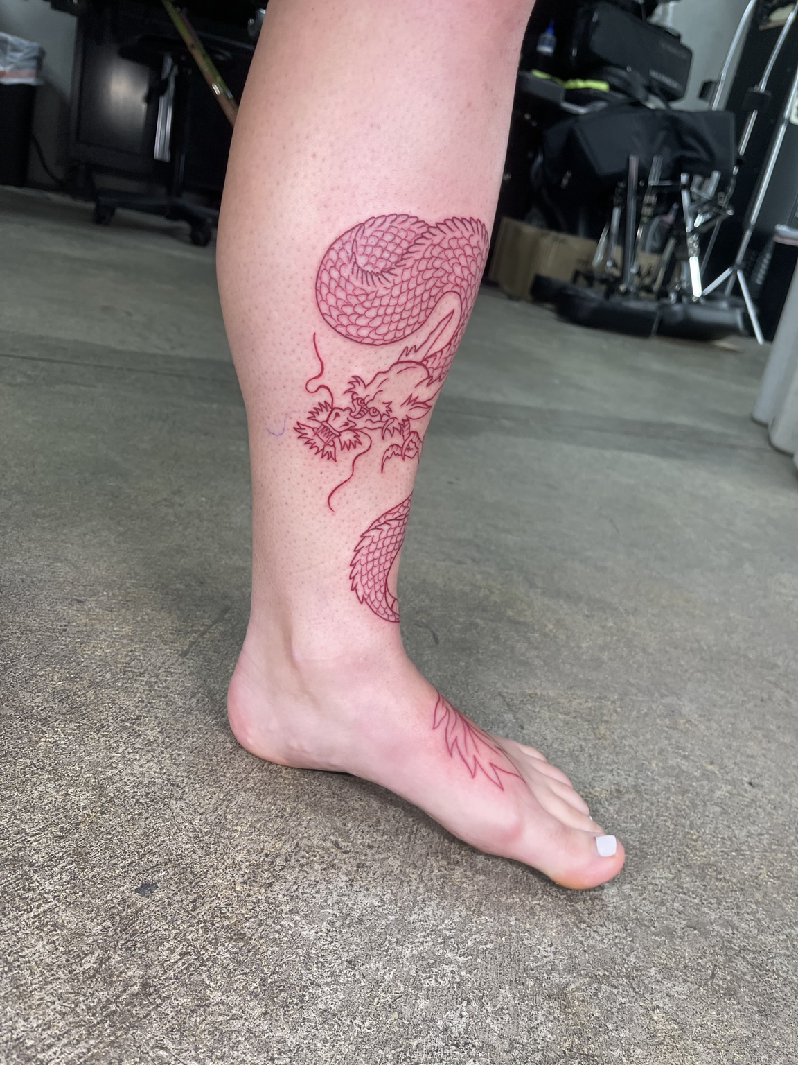 Red outline leg tattoo process view four