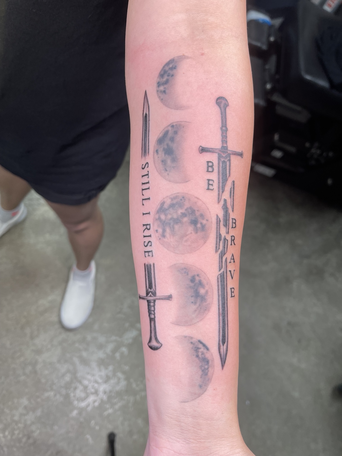 Sword and feather forearm tattoo alternate view
