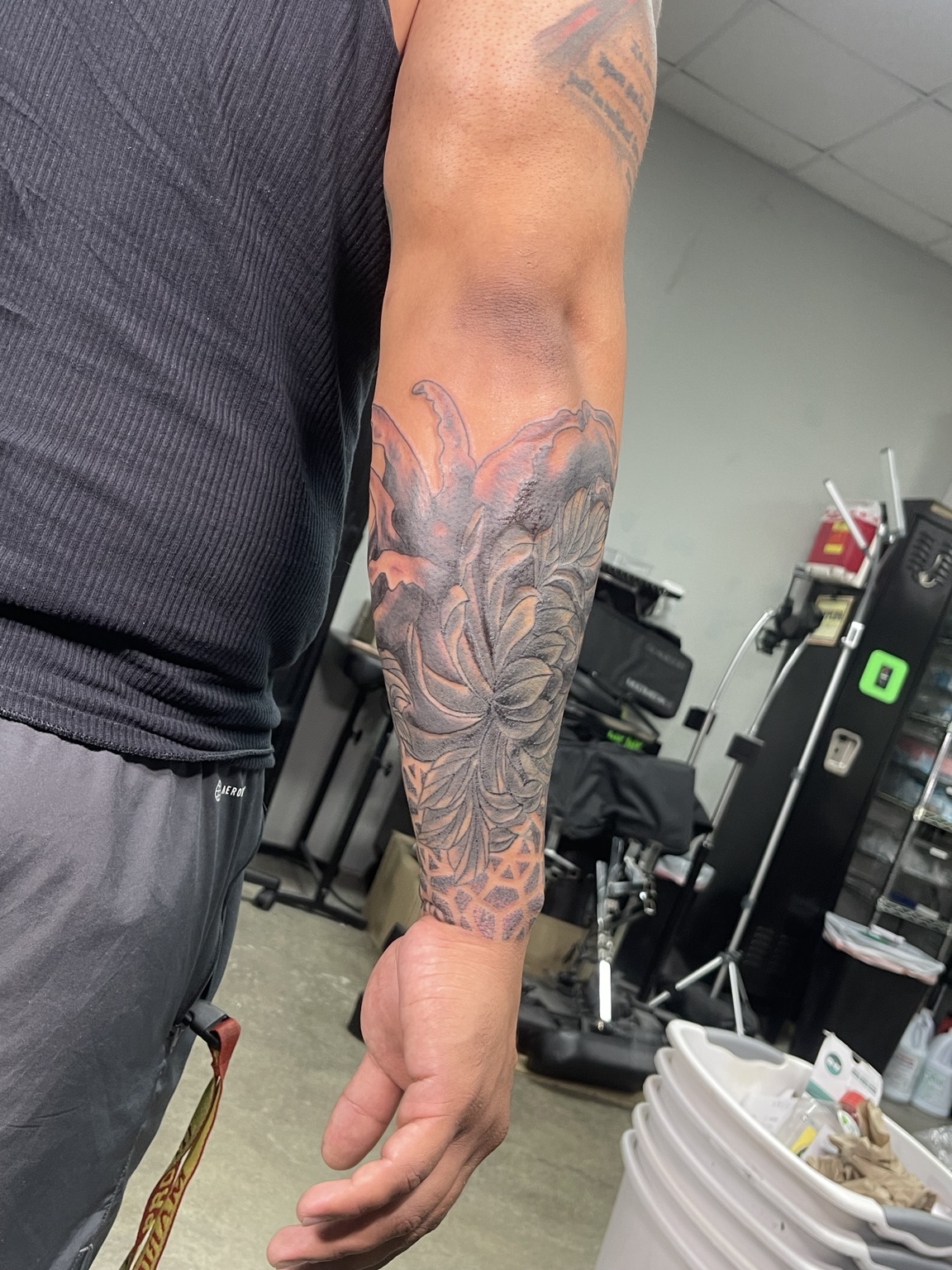 Black and grey peony forearm tattoo alternate view