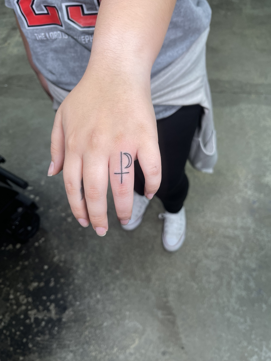 Small hand symbol tattoo